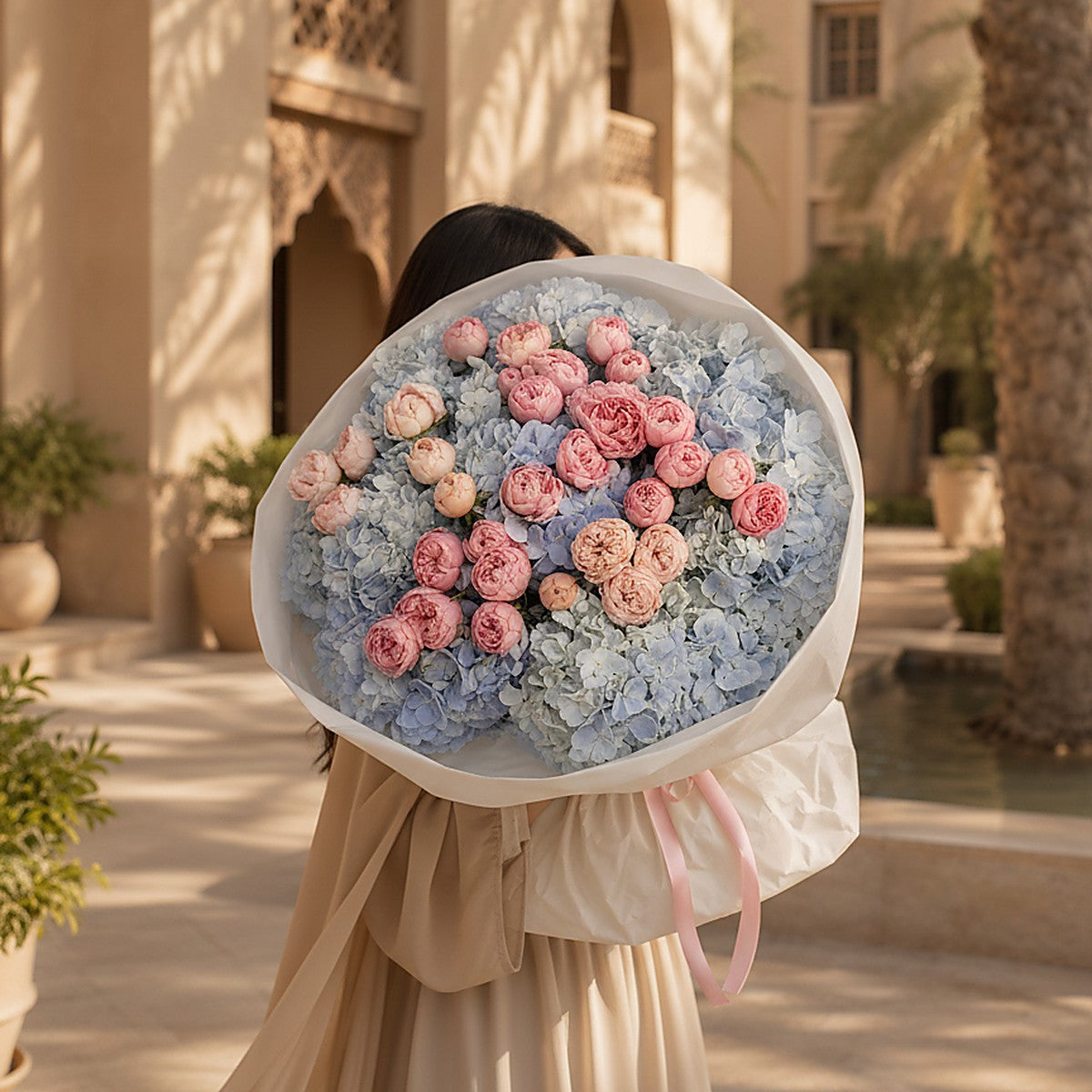 Side angle of Azure Bloom showing soft pink ribbon and luxury white wrapping by Aiwa Flowers Dubai