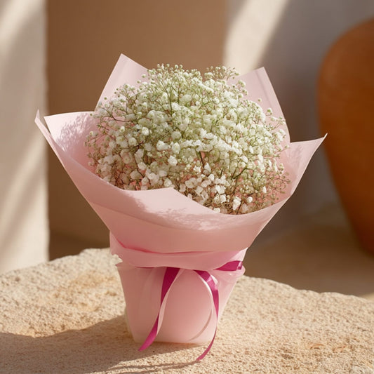 Hand-tied gypsophila bouquet in soft light pink wrapping, handcrafted by Aiwa Flowers in Dubai