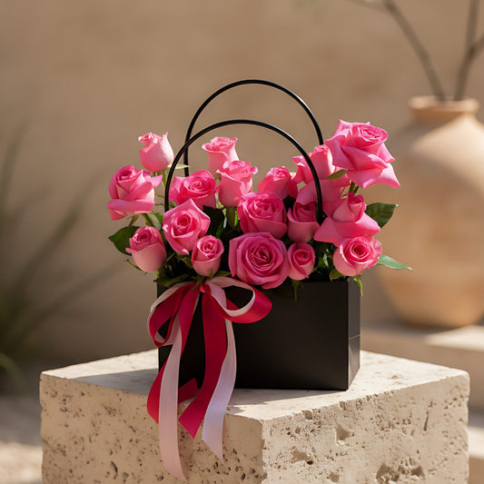 Pinko bag-box arrangement with fresh pink roses by Aiwa Flowers Dubai