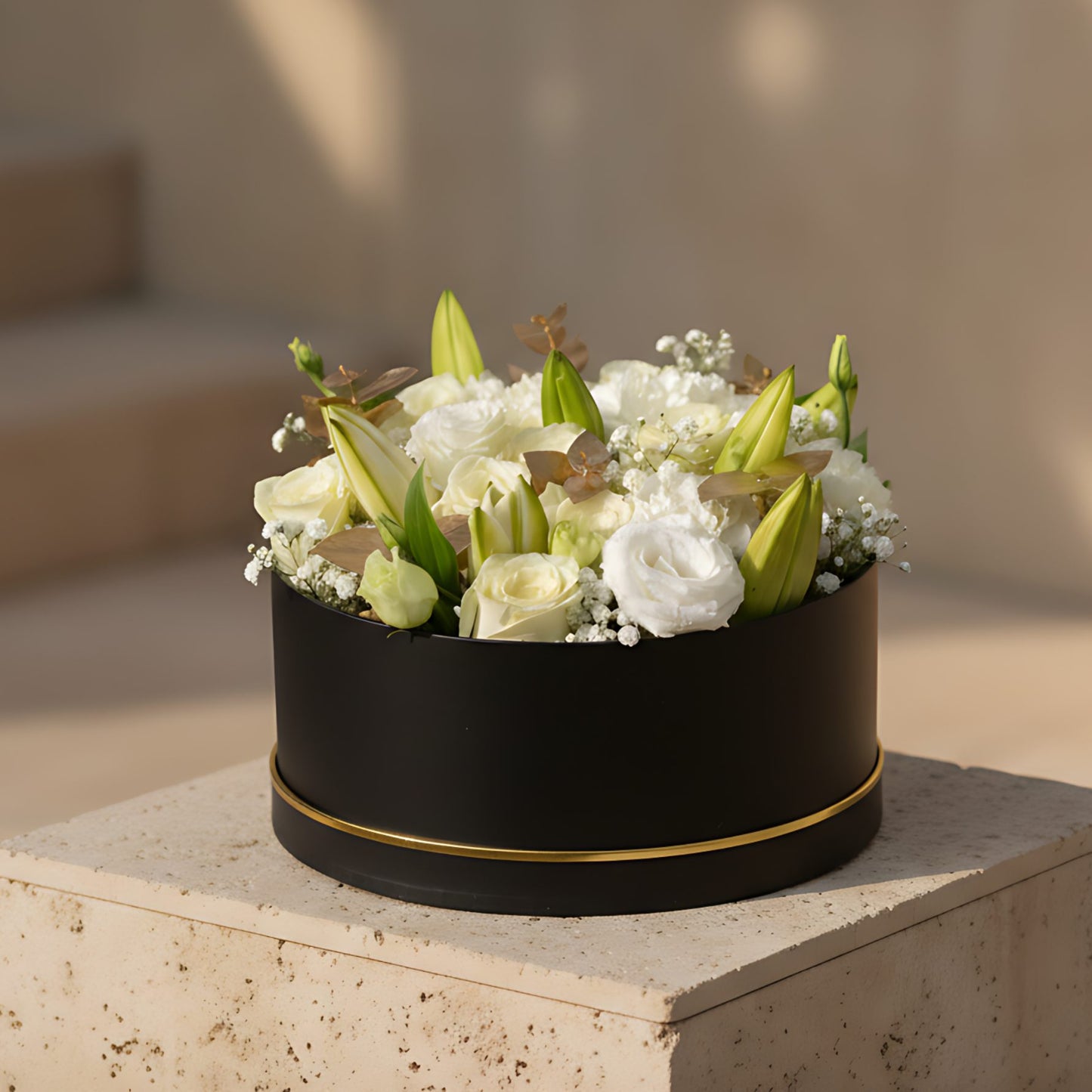 Black box floral arrangement with white roses, white carnations, white lilies, lisianthus, and soft white accents