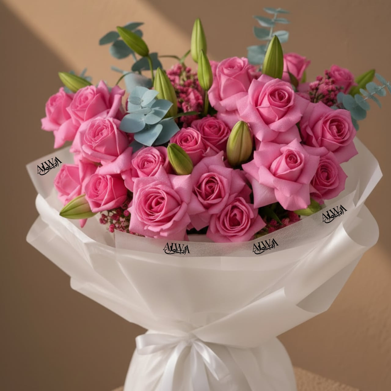 Close-up of pink roses and lily buds in white wrap by AIWA Flowers Dubai
