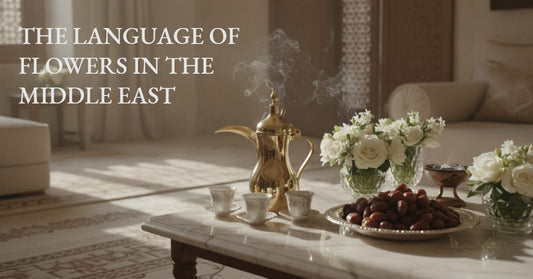 Gold Arabic coffee pot, white roses, and dates arranged on a marble table in a majlis setting