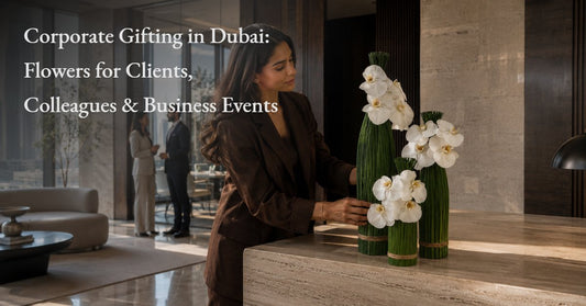 Florist arranging white orchid corporate flower arrangements in a Dubai office reception