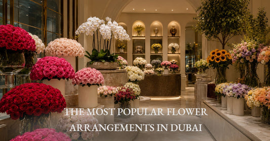 Elegant floral display of red, pink, and white rose bouquets alongside orchids and sunflowers in a Dubai flower shop