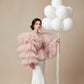 Woman holding bouquet of 10 white helium balloons