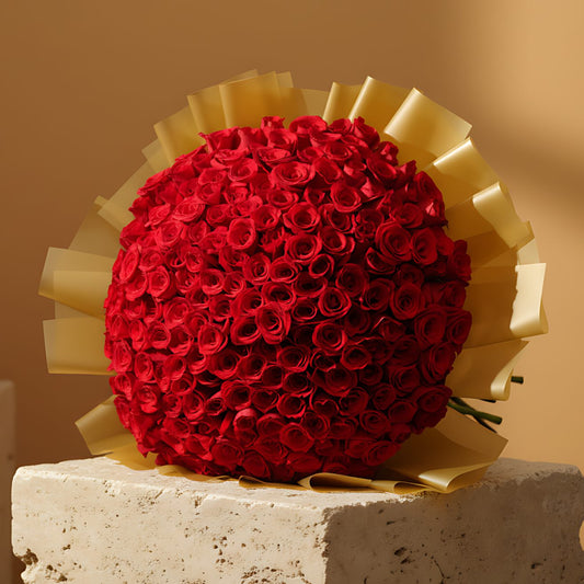 201 Desert Rose hand-tied bouquet with 201 fresh red roses in gold wrapping by Aiwa Flowers