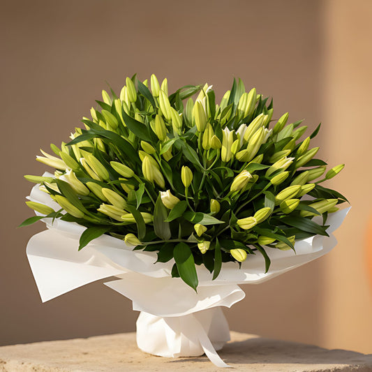 55 Lilies Misty hand-tied bouquet with 55 white lilies in white wrapping by Aiwa Flowers