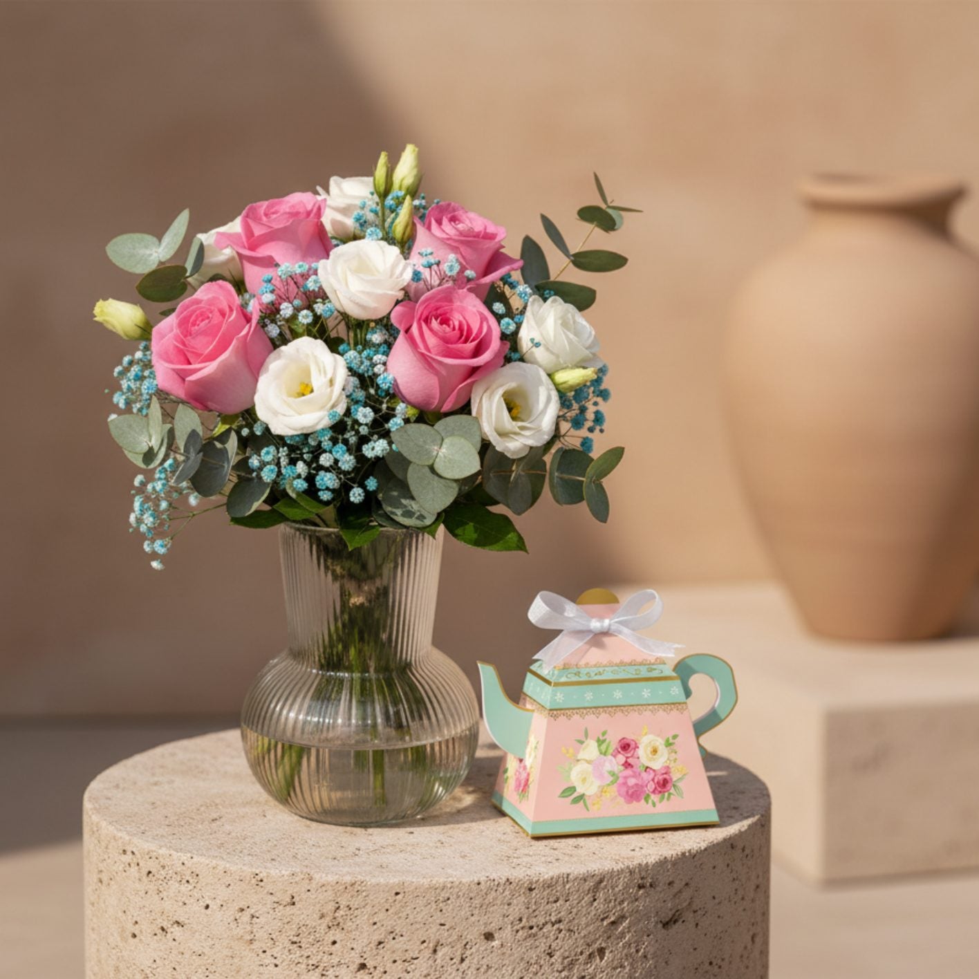 Bloom for Her Vase arrangement with pink roses, white lisianthus, blue baby's breath and eucalyptus in ribbed glass vase.