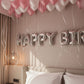 pink and white helium balloon ceiling decoration with ribbons birthday setup Dubai
