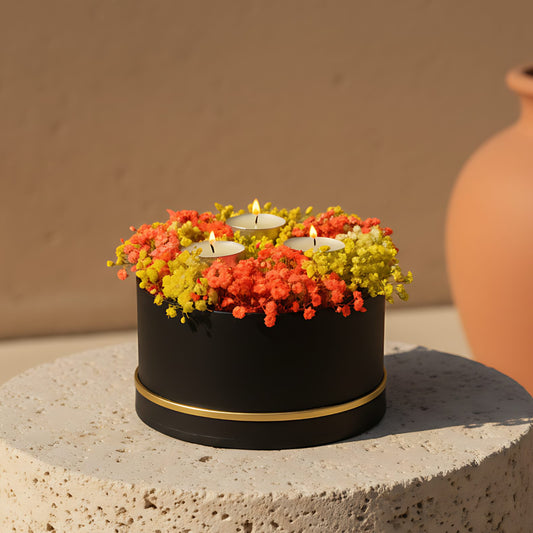 Black box arrangement with yellow and orange gypsophila and decorative candles