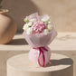 Deva bouquet with pink hydrangea, white roses, and white flowers wrapped in soft pink paper.