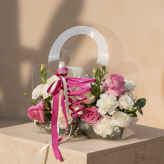 Clear bag floral arrangement with pink and white roses, lisianthus, carnations, gypsophila, and eucalyptus