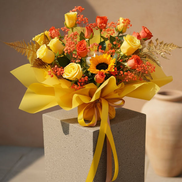 Festival of Lamps bouquet with sunflower, yellow and orange roses, golden fern and candle in yellow wrapping.