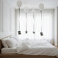 white helium balloons with attached photos floating above bed minimal room decoration Dubai