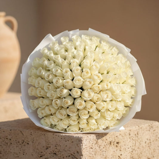 201 Whity hand-tied bouquet of 201 white roses wrapped in white paper by Aiwa Flowers Dubai