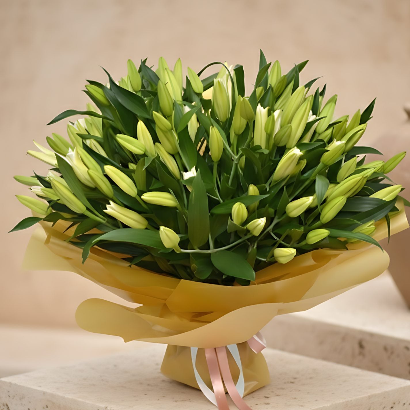 55 Lilies Gold hand-tied bouquet of white lilies wrapped in gold paper by Aiwa Flowers Dubai
