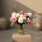 Al Adha Fest floral arrangement with pink and white roses, lilies, hydrangeas, eucalyptus, and Arabic topper in clear vase by Aiwa Flowers Dubai