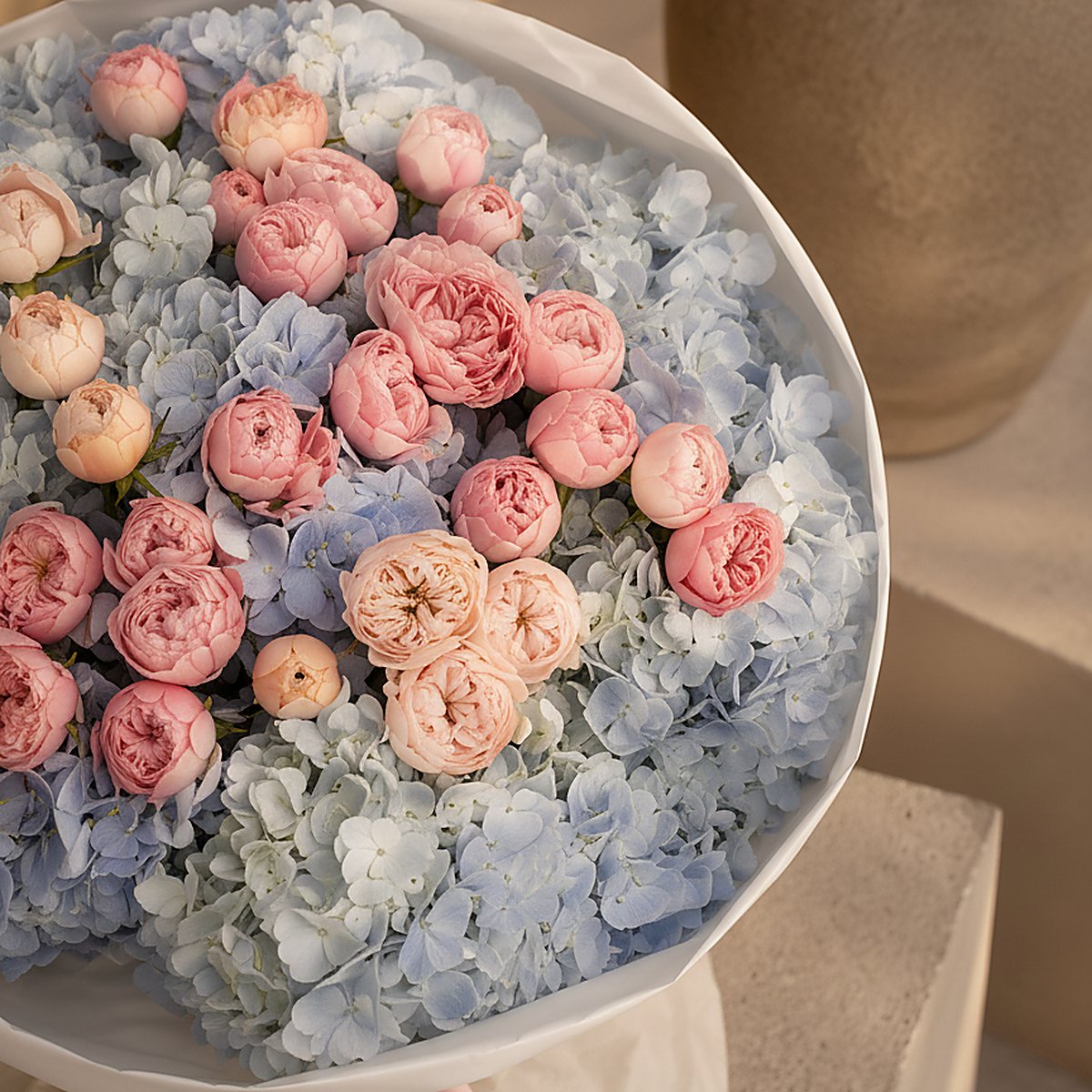Close-up of blue hydrangea petals and blush spray roses in Azure Bloom by Aiwa Flowers Dubai