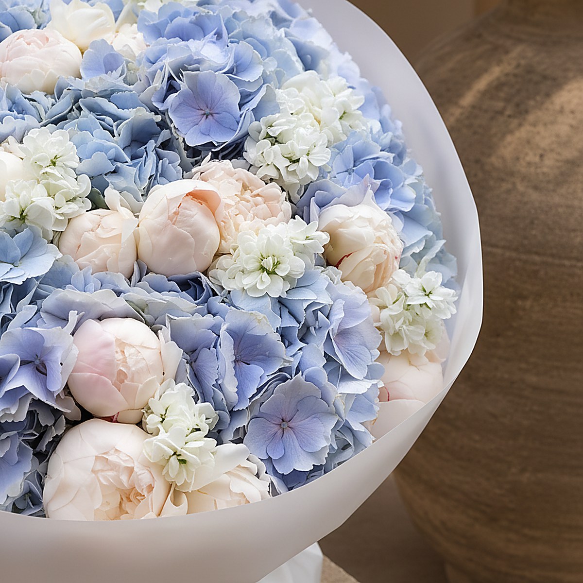 Close-up of blue hydrangea and pink peony in Blue Veil by Aiwa Flowers Dubai