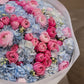 Close-up of pink ranunculus and blue hydrangea petals in Celestia by Aiwa Flowers Dubai