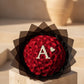 Premium red rose bouquet with personalized initial design and elegant black wrapping