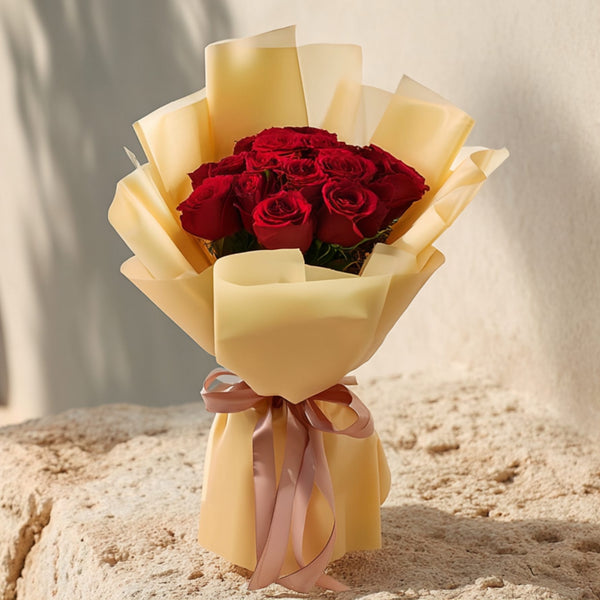 Hand-tied bouquet of 15 fresh red roses in elegant gold wrapping by Aiwa Flowers
