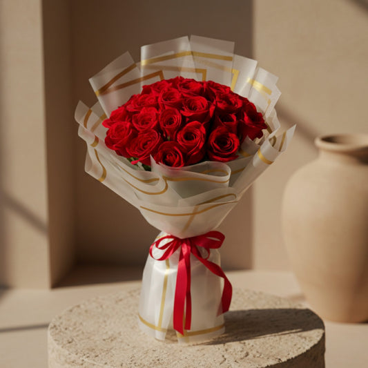 Golden Touch hand-tied bouquet of 25 red roses in trendy wrapping by Aiwa Flowers Dubai