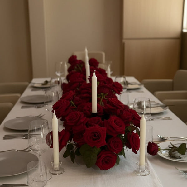 Luxury 1 meter red rose table centerpiece with four candles arranged along a dining table setting.