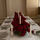 Luxury 1 meter red rose table centerpiece with four candles arranged along a dining table setting.