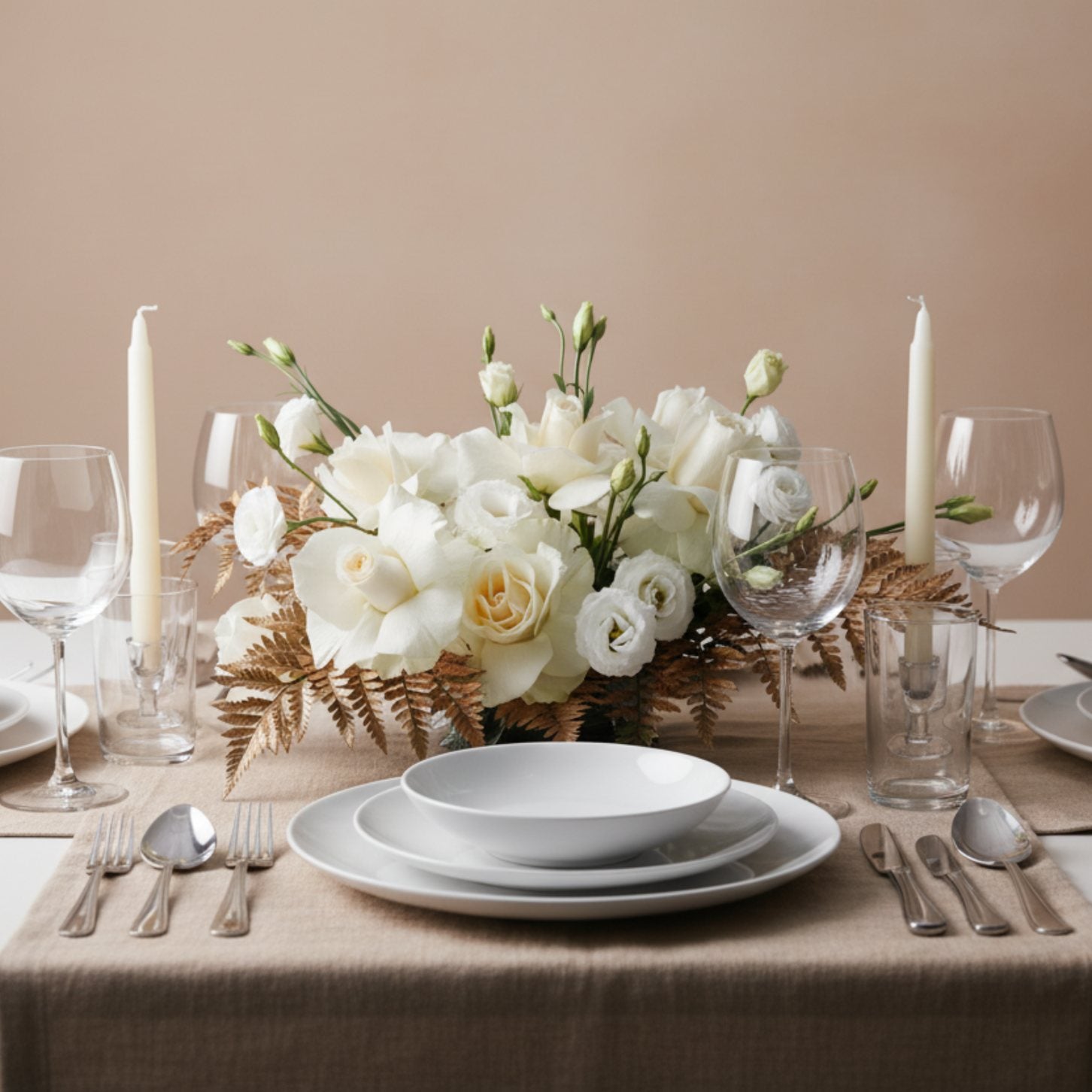 Elegant ivory rose and white lisianthus floral centerpiece arranged on a dining table with soft neutral styling.