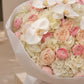 Top-down view of Ivory Orchid hand-tied bouquet by Aiwa Flowers Dubai