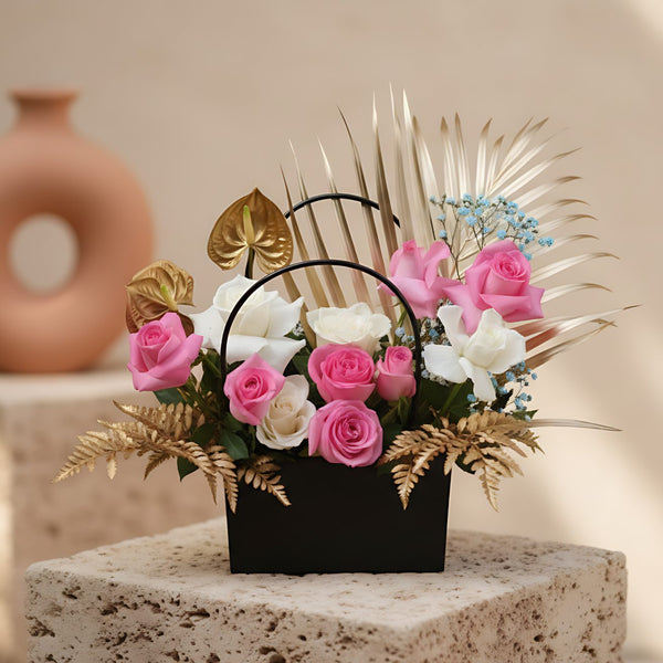 Lavish Garden bag-box arrangement with pink and white roses, blue gypsophila, anthuriums, and foliage by Aiwa Flowers Dubai