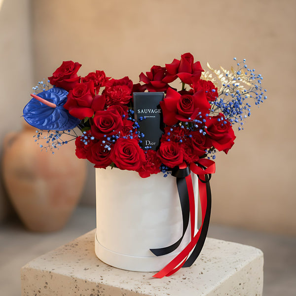 Lord white velvet box arrangement with red roses, red carnations, blue anthurium, and Dior Sauvage perfume by Aiwa Flowers Dubai