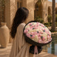 Side angle of Noctelle showing 50-peony composition with black wrap by Aiwa Flowers Dubai