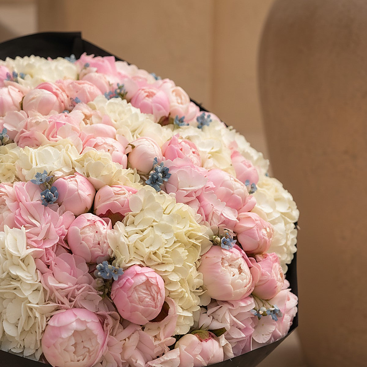 Top-down view of Noctelle hand-tied bouquet in black wrap by Aiwa Flowers Dubai