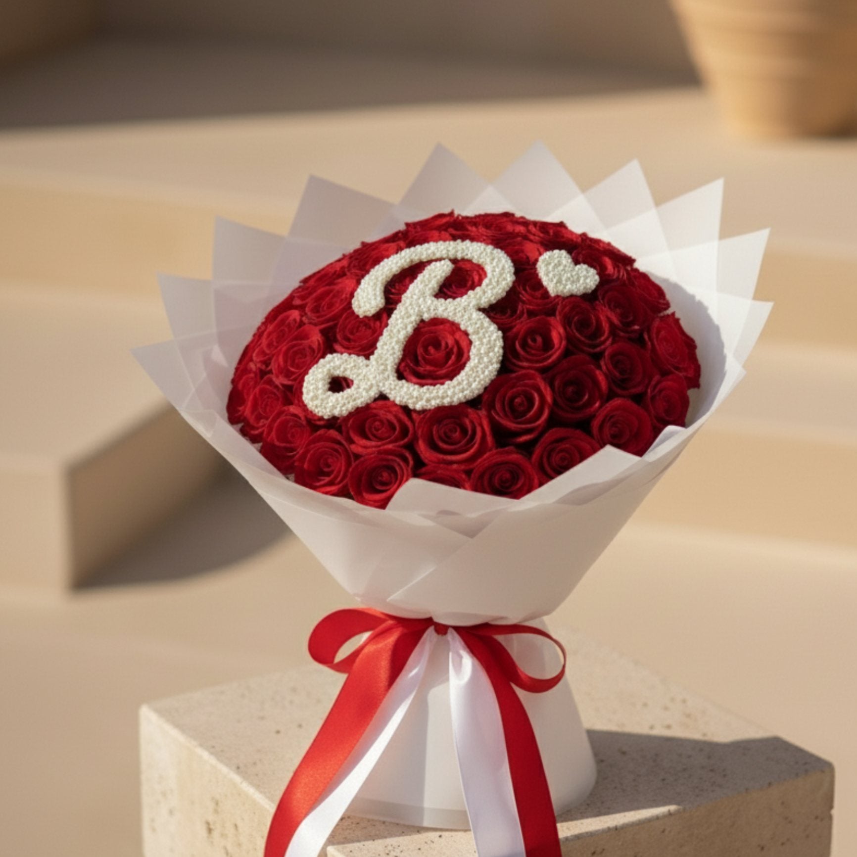 Premium personalized red rose bouquet with white wrapping and satin ribbon