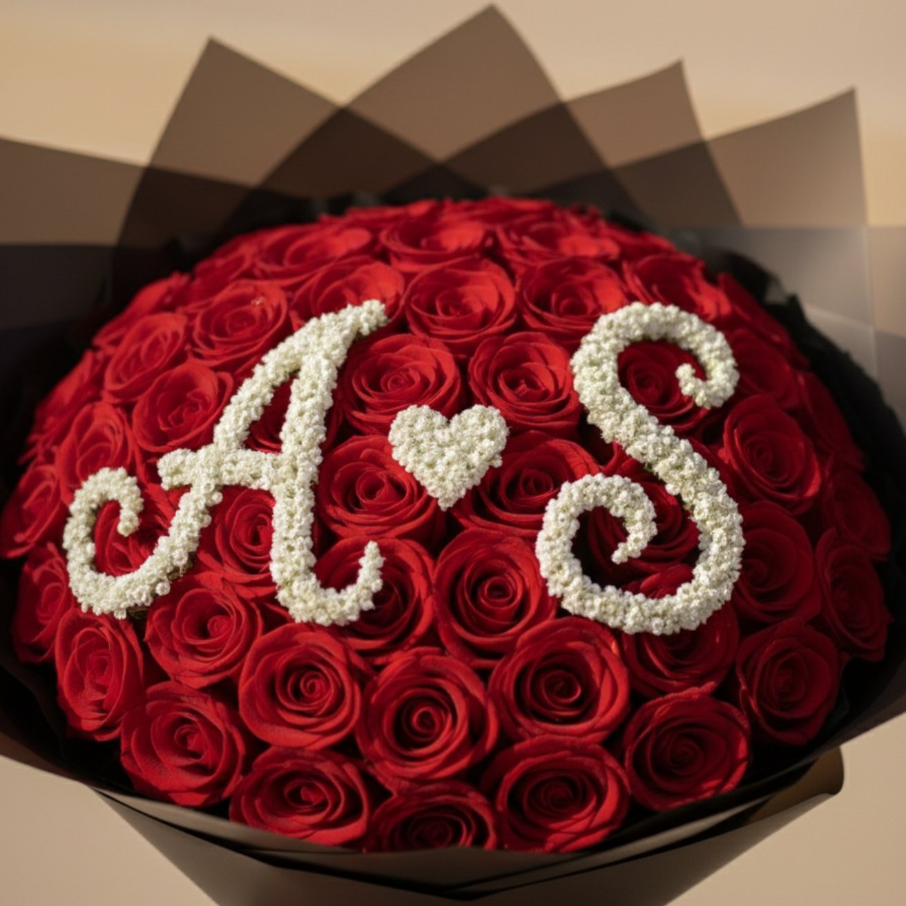 Custom couple initial rose bouquet with elegant black wrapping and satin ribbon