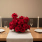 Luxury rose floral centerpiece arranged in a low vase for elegant dining table decoration.