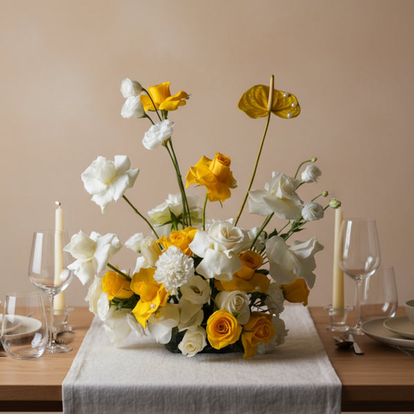Solar Bloom rose centerpiece with golden yellow and ivory roses arranged in a sculptural garden-style table arrangement.