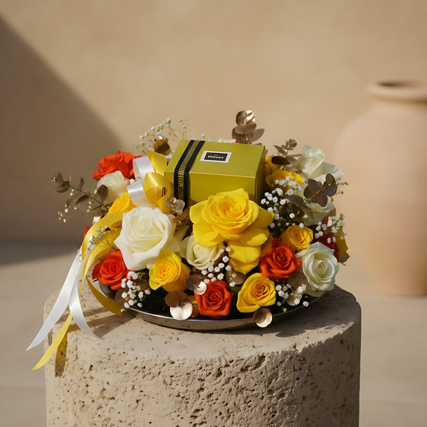 Taubah floral tray arrangement with mixed roses, eucalyptus, gypsophila, and Patchi chocolates by Aiwa Flowers Dubai