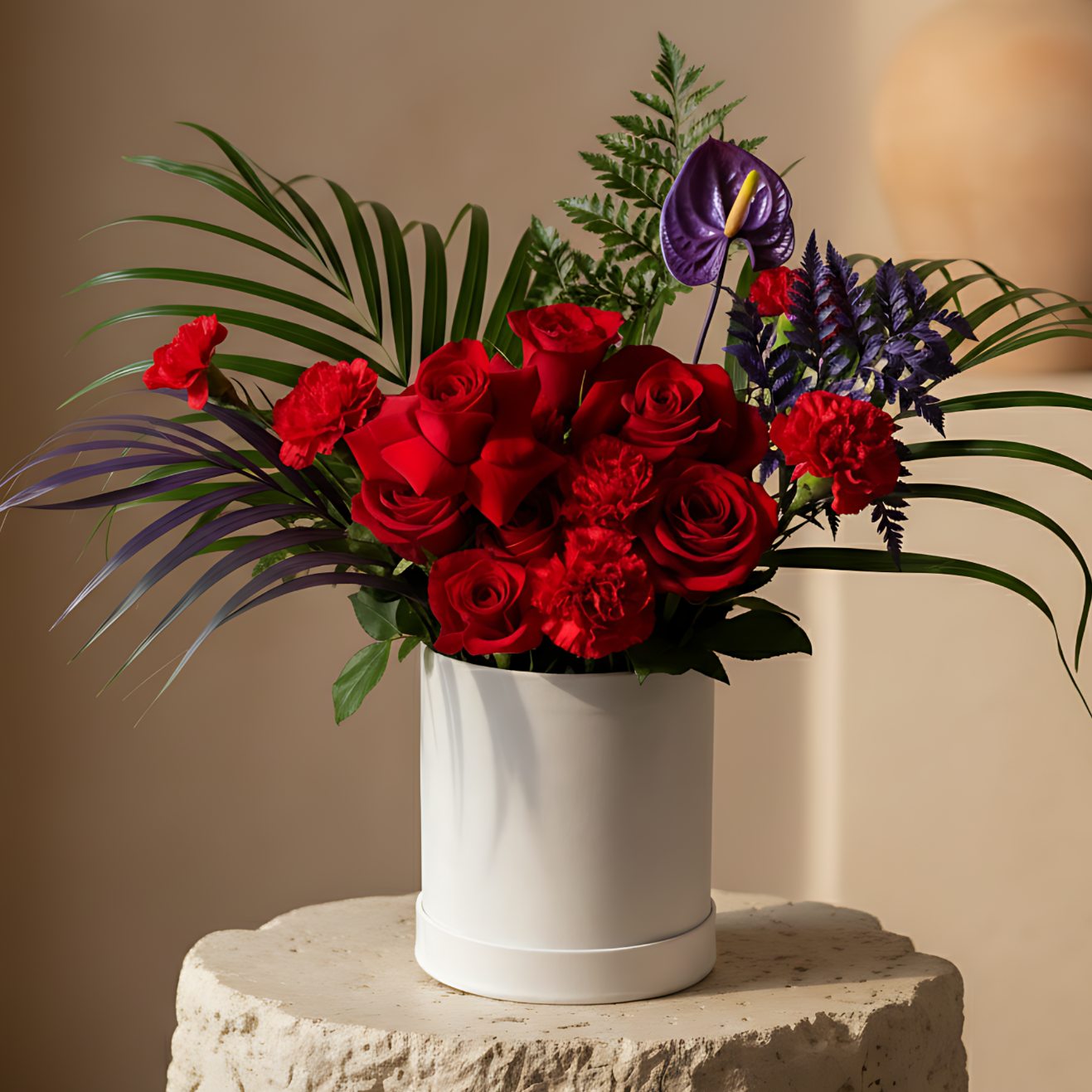 Tropical Fusion white velvet box arrangement with red roses, carnations, anthurium, and foliage by Aiwa Flowers Dubai
