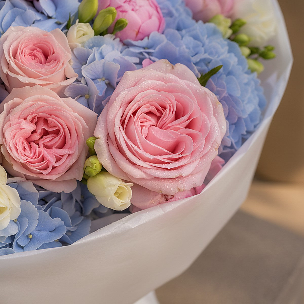 Close-up of blue hydrangea and blush peony in Velour Sky by Aiwa Flowers Dubai
