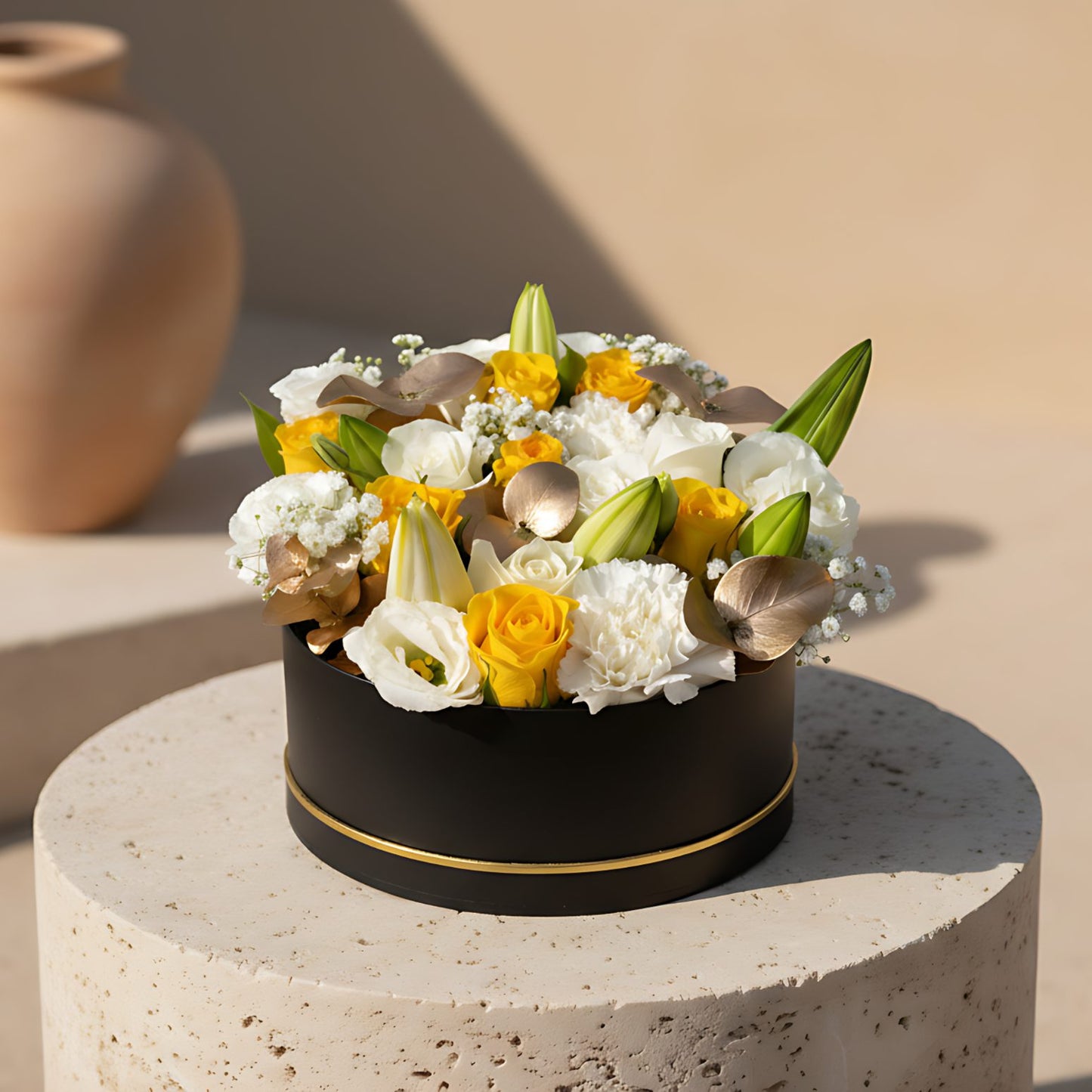 Elegant black box flower arrangement with white and yellow roses, lilies, carnations, and soft white accents