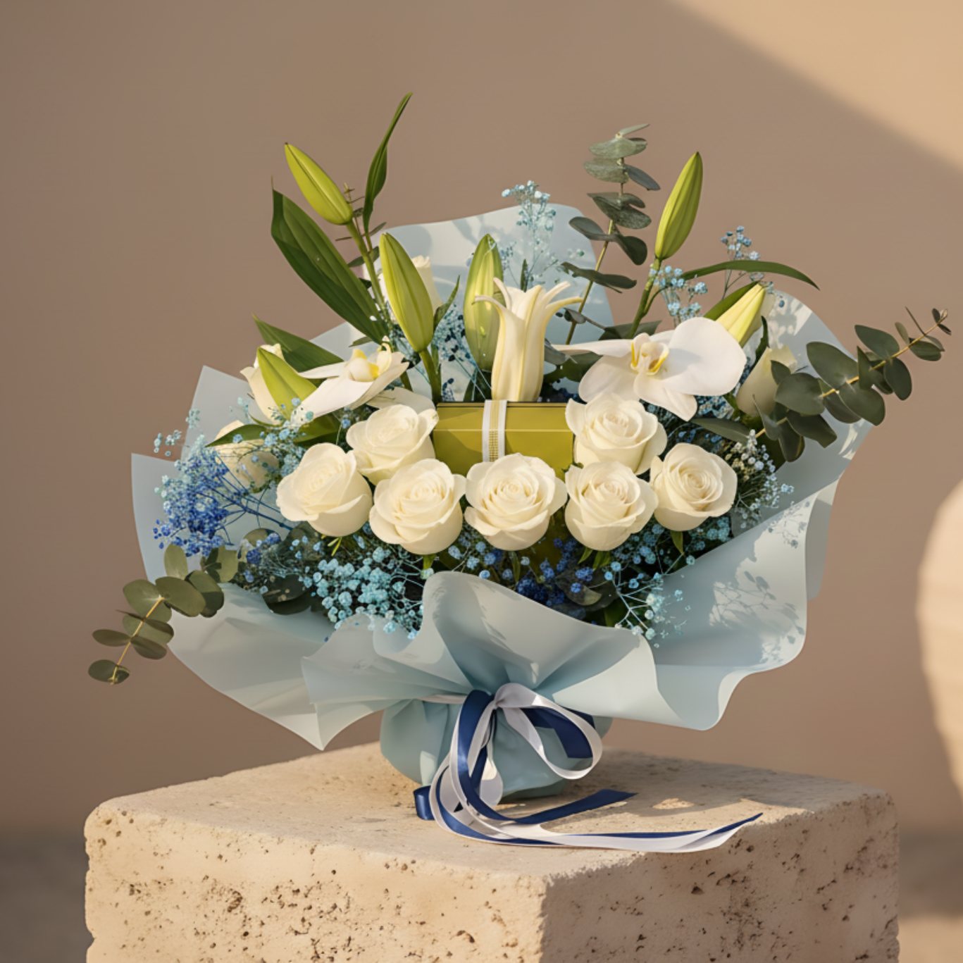 Iceberg bouquet with white roses, lilies, orchids and Patchi chocolate box in blue wrapping.