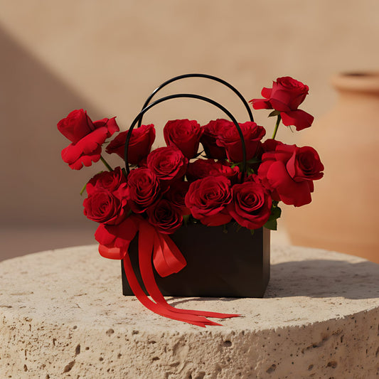 Black bag-box arrangement with 15–20 fresh red roses
