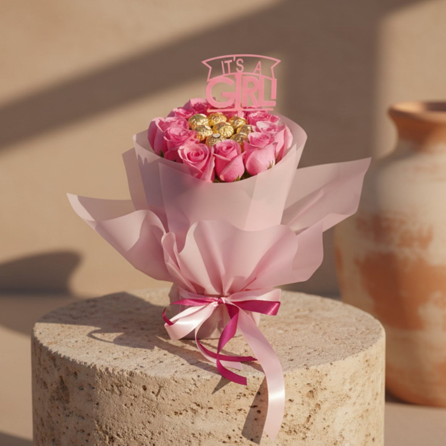 It’s a Girl bouquet with pink roses, Ferrero Rocher chocolates and baby girl topper in pink wrapping.