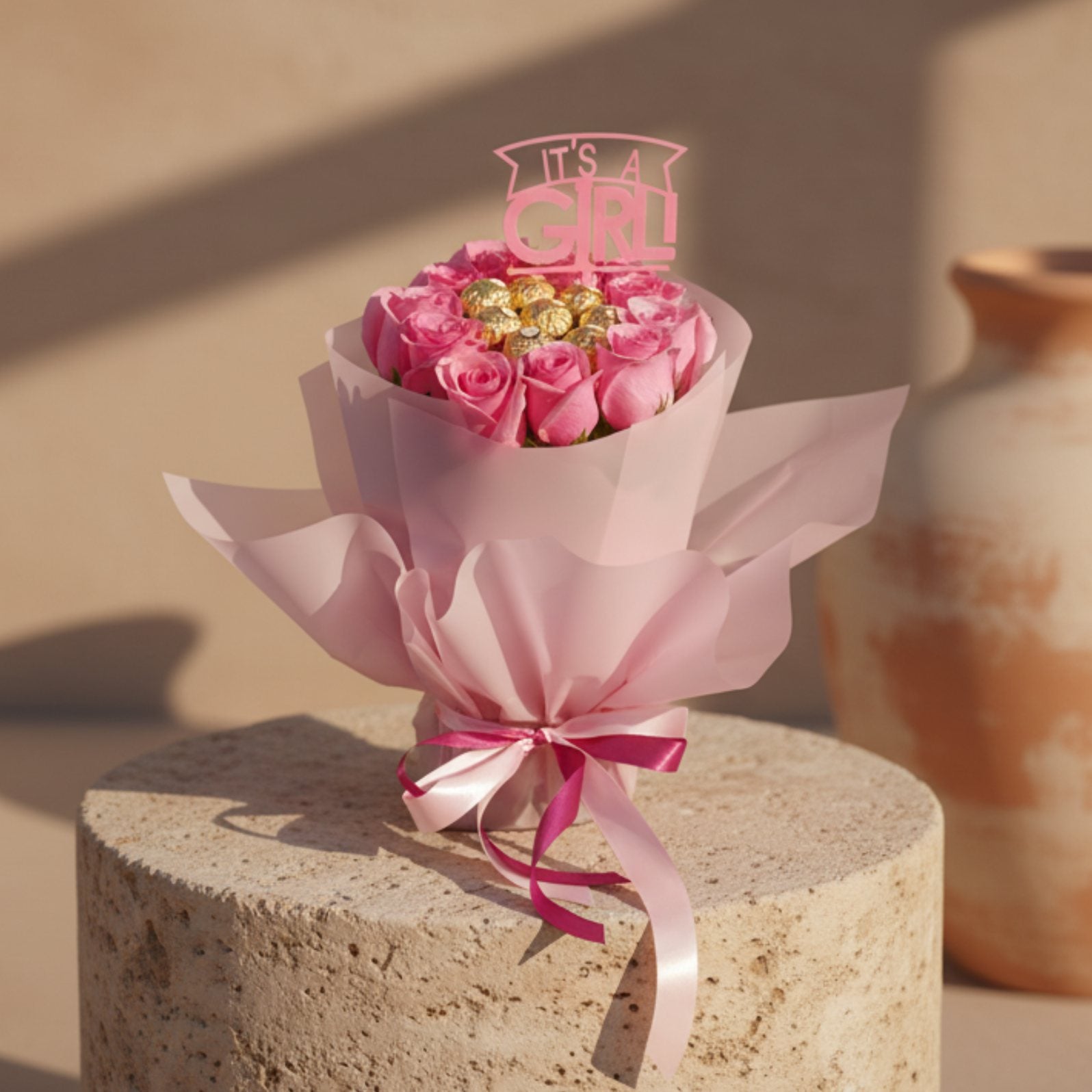 It’s a Girl bouquet with pink roses, Ferrero Rocher chocolates and baby girl topper in pink wrapping.