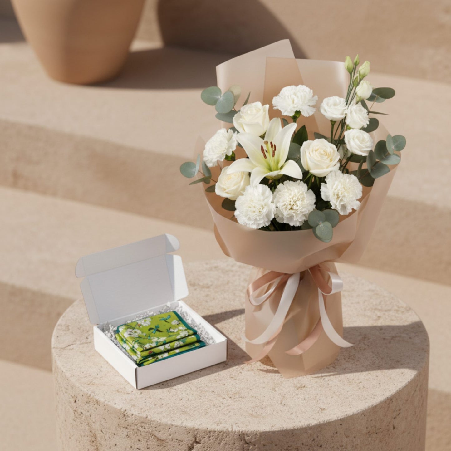 Ivory Promise bouquet with white lilies, roses and carnations paired with folded silk scarf gift box.
