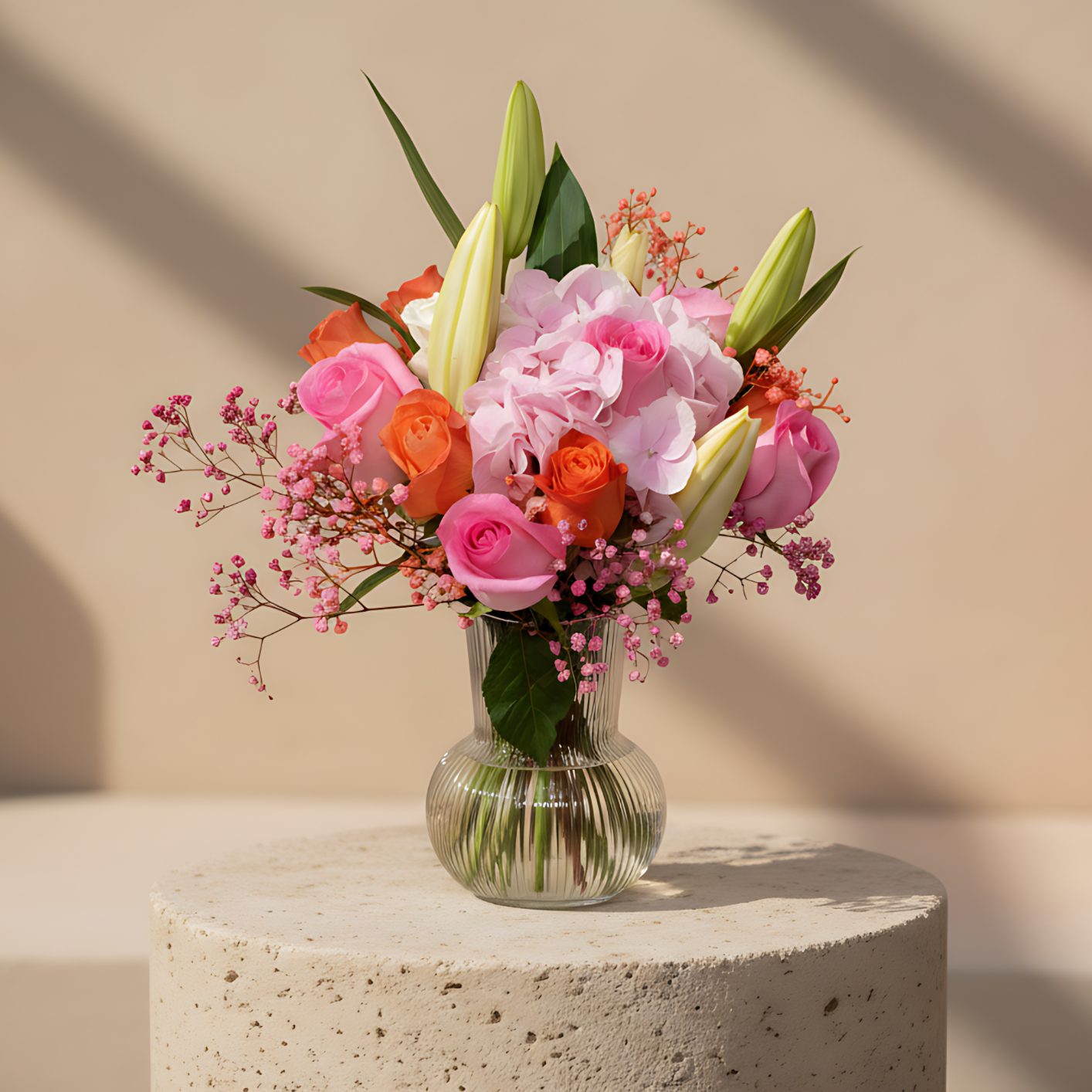 Clear glass vase arrangement with pink roses, pink hydrangea, white lisianthus, lily, and pink fern