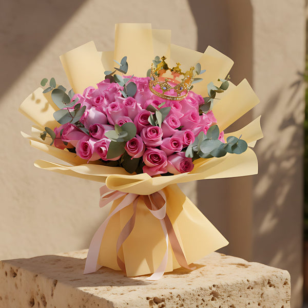 Hand-tied bouquet of 55 pink roses with eucalyptus and crown detail wrapped in luxurious gold paper